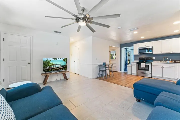 Living room featuring recessed lighting, ceiling fan, and light tile patterned floors
