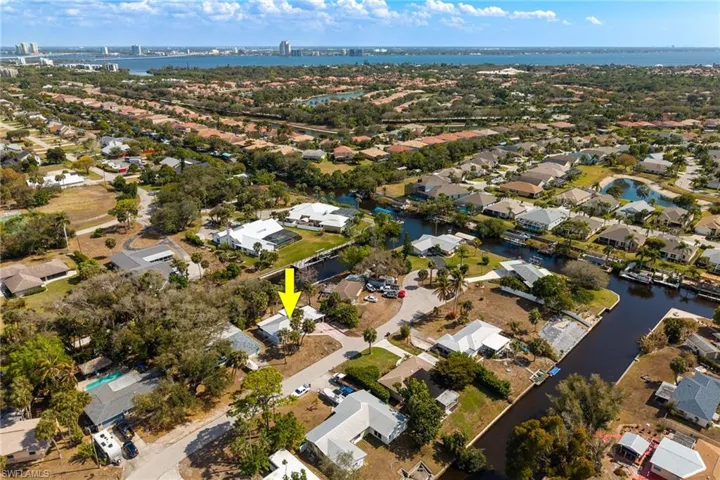 Aerial perspective of suburban area with a nearby body of water