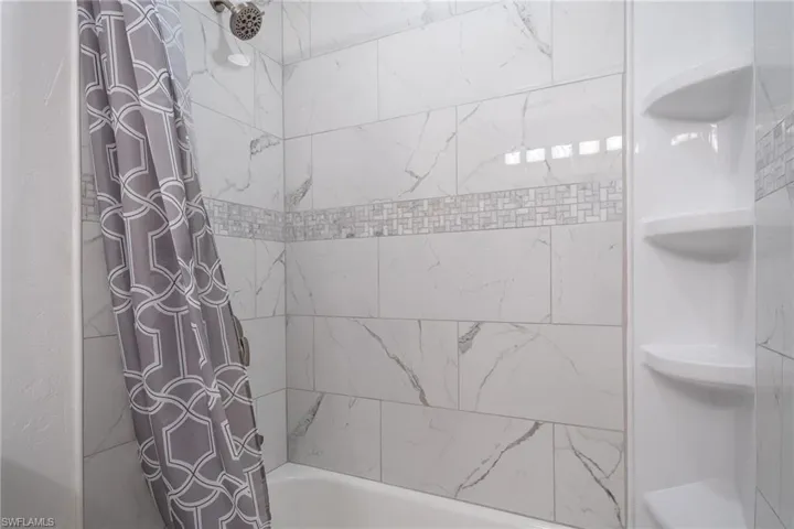 Bathroom with shower / bath combo with shower curtain