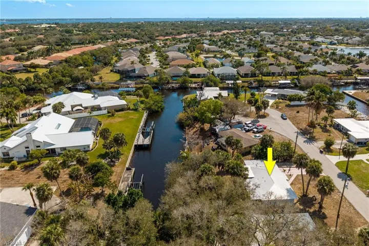 Aerial perspective of suburban area with a nearby body of water