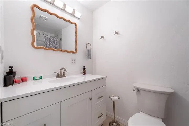 Full bathroom with vanity and a shower with curtain