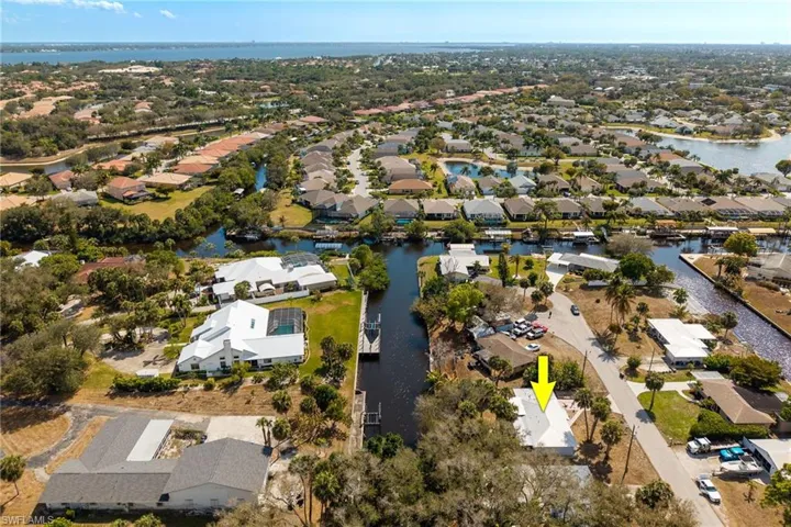View of property location featuring a nearby body of water and nearby suburban area