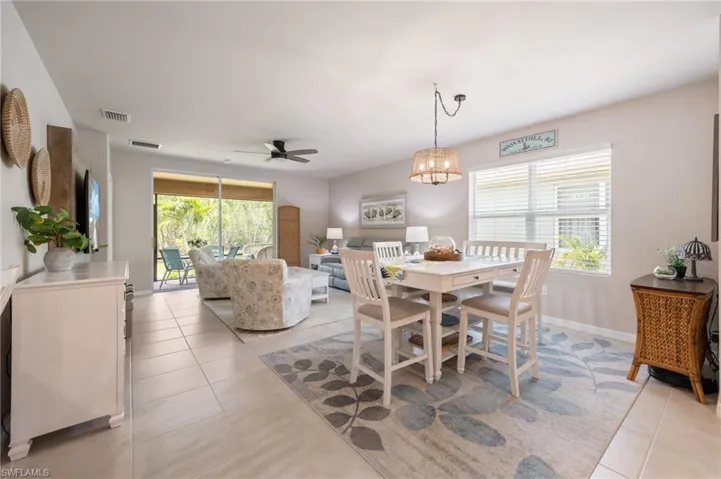 Open-concept dining and living area featuring tile flooring throughout