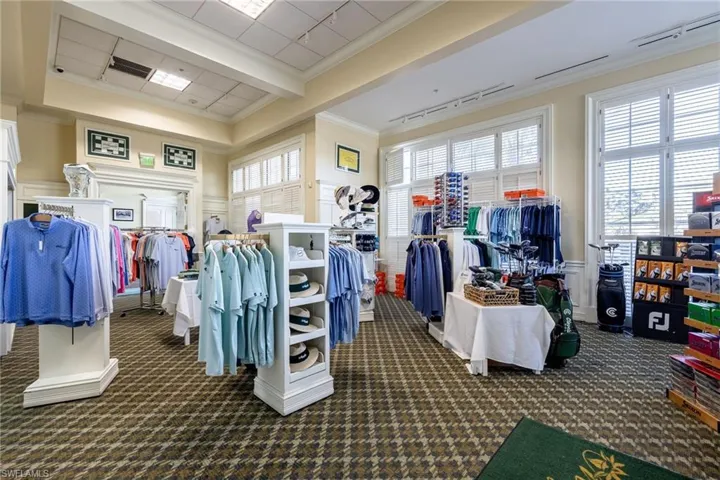 Interior space with patterned carpet flooring, large windows featuring white plantation shutters, and recessed lighting