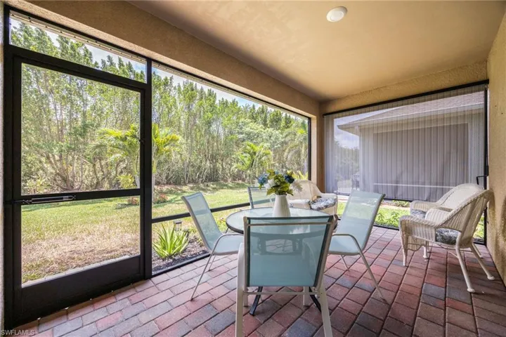 Screened patio featuring a multi-toned paver floor and recessed lighting