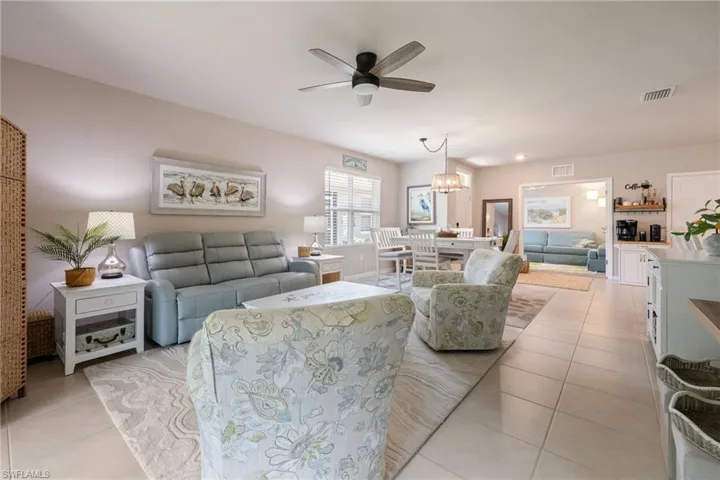 Open-concept living space featuring tile flooring, a ceiling fan, and recessed lighting