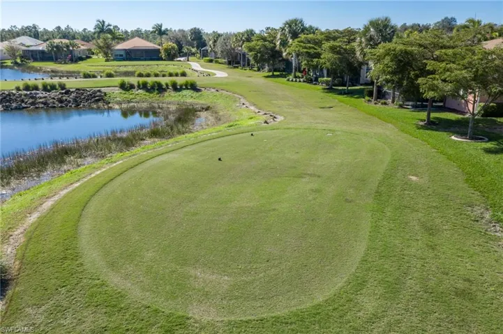 Manicured golf course green with surrounding lush grass