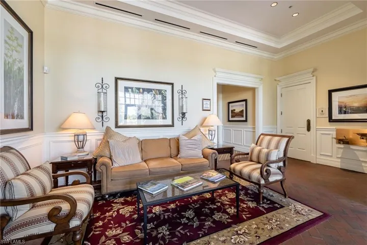Neutral-toned walls accented by white wainscoting and crown molding