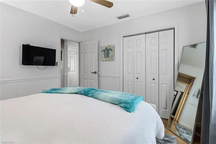 Bedroom featuring a closet, wood finished floors, and ceiling fan