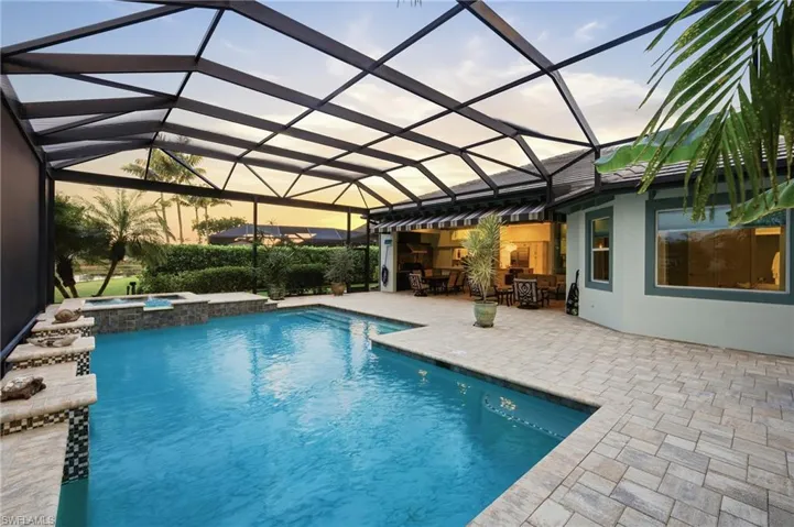 Private backyard setting with mature landscapingand lake views