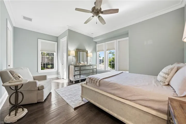 Spacious guest bedroom with hardwood flooring