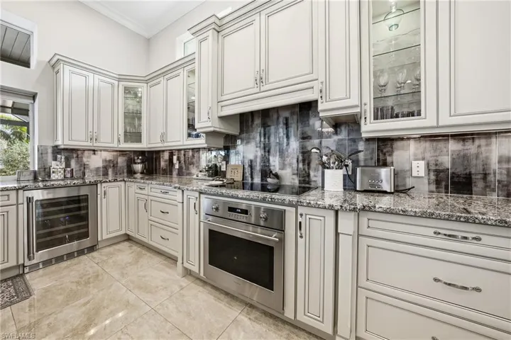 Chef’s kitchen with center island, prep sink, andlake views