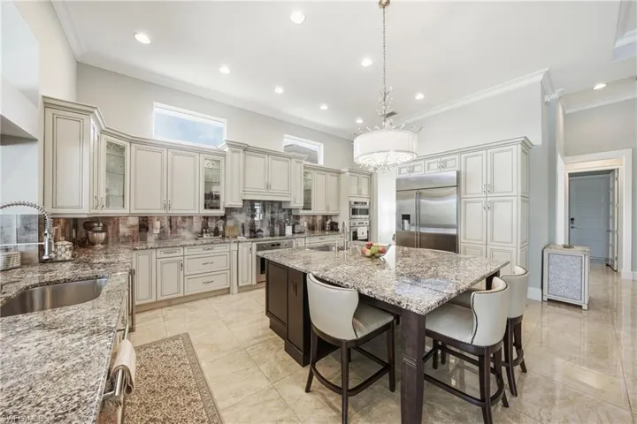 Chef’s kitchen with center island, prep sink, andlake views