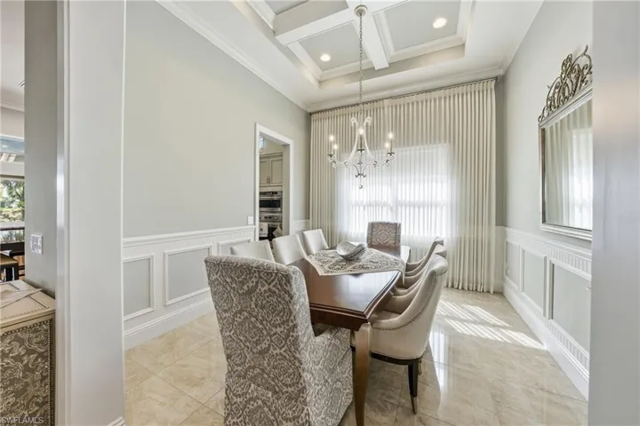 Formal dining space with coffered ceiling andrefined architectural details