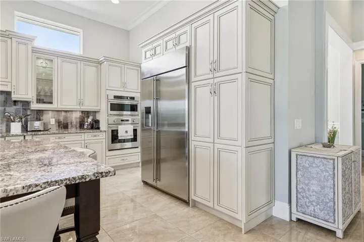 Chef’s kitchen with center island, prep sink, andlake views