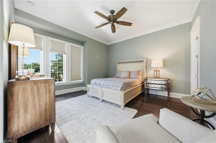 Spacious guest bedroom with hardwood looking tile flooring