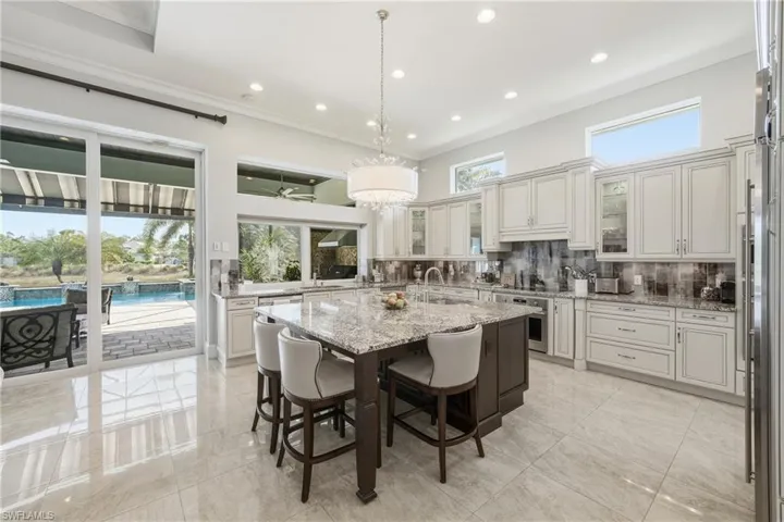 Chef’s kitchen with center island, prep sink, andlake views