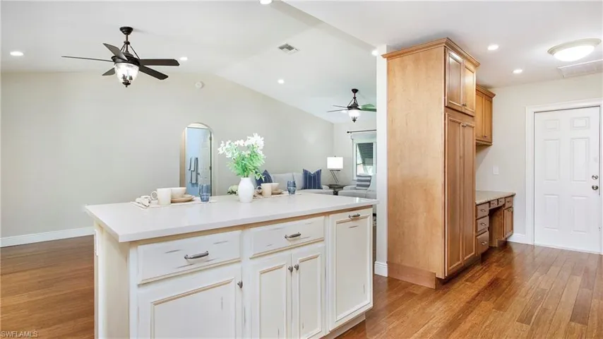 Large pantry and built in desk to right of kitchen island