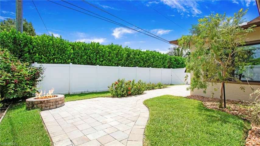 Calusa hedges planted behind 6' privacy fence for added privacy and color