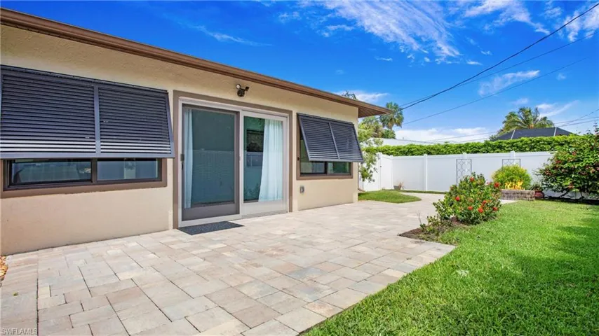 Large open paver patio in rear of home