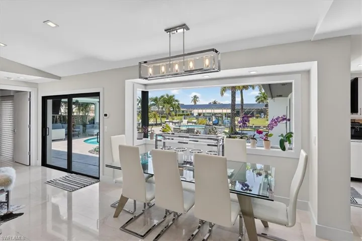 Dining area with large impact window to back yard oasis
