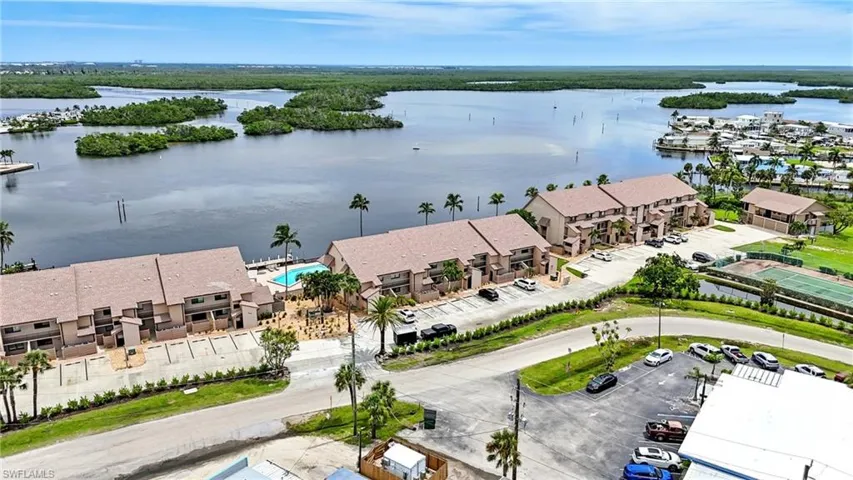 Aerial perspective of suburban area featuring a nearby body of water