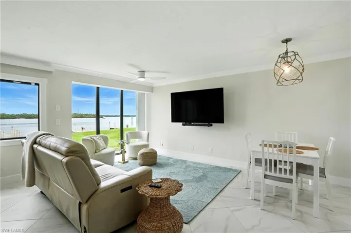 Living room with light marble finish floors and ceiling fan