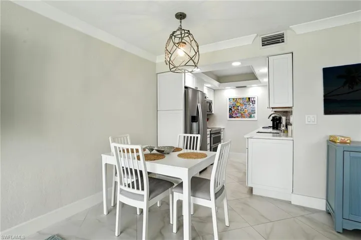 Dining room featuring recessed lighting and ornamental molding