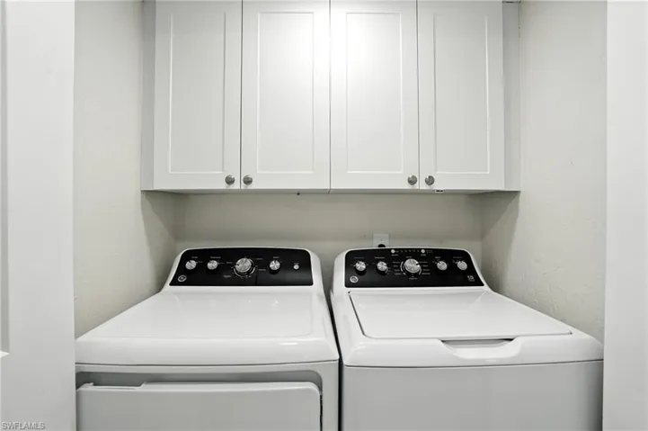 Laundry area featuring cabinet space and independent washer and dryer