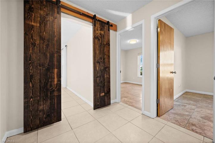 Hallway with solid wood barn doors for extra privacy