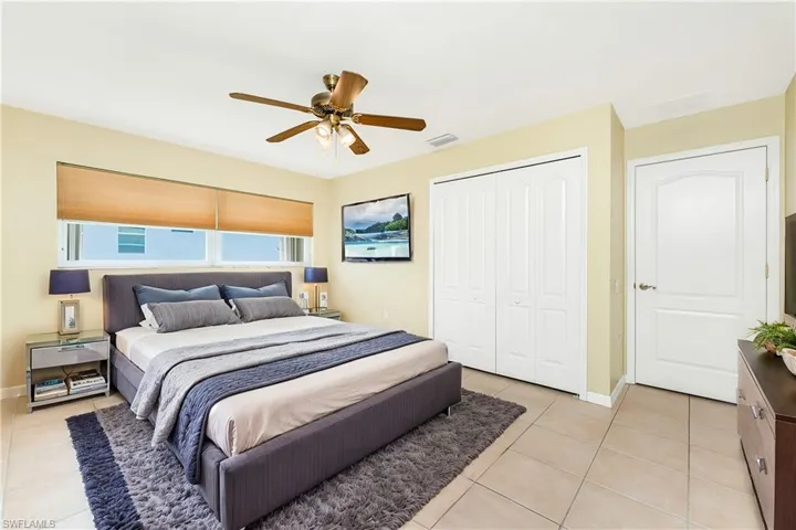 Virtual Staged Bedroom featuring light tile patterned floors, a closet, baseboards, and ceiling fan