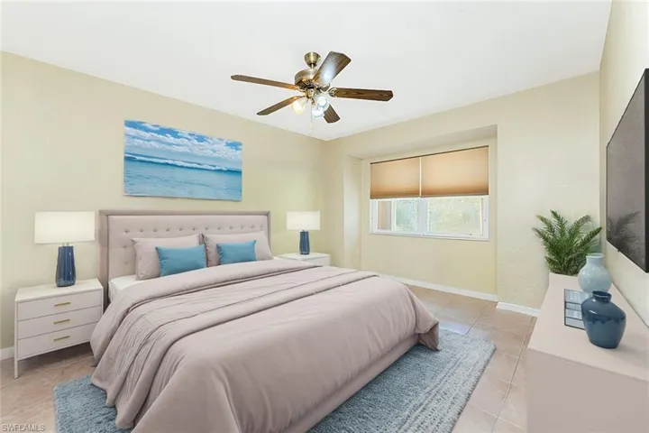Virtual Staged Bedroom with light tile patterned floors, a ceiling fan, and baseboards