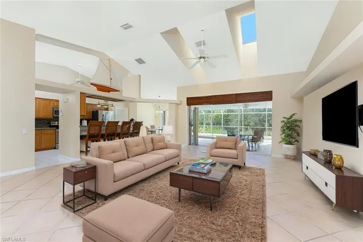Virtual Staged Living area with light tile patterned flooring, visible vents, and a ceiling fan