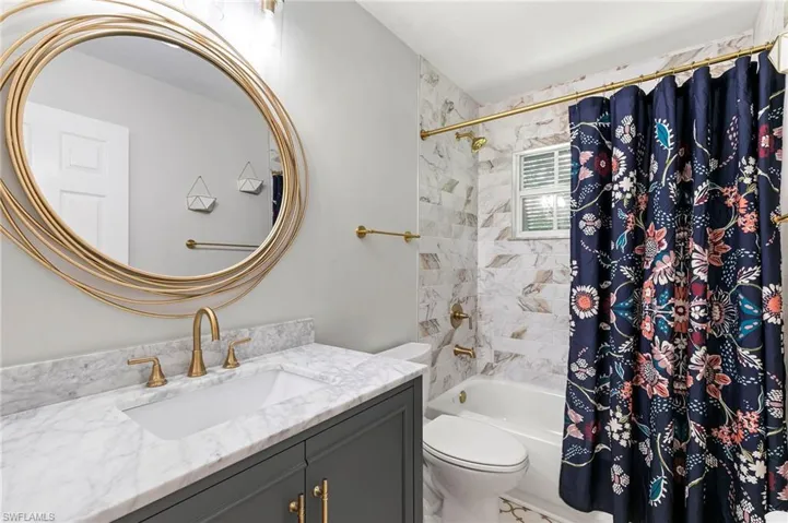 Full bathroom with vanity and shower / bath combination with curtain