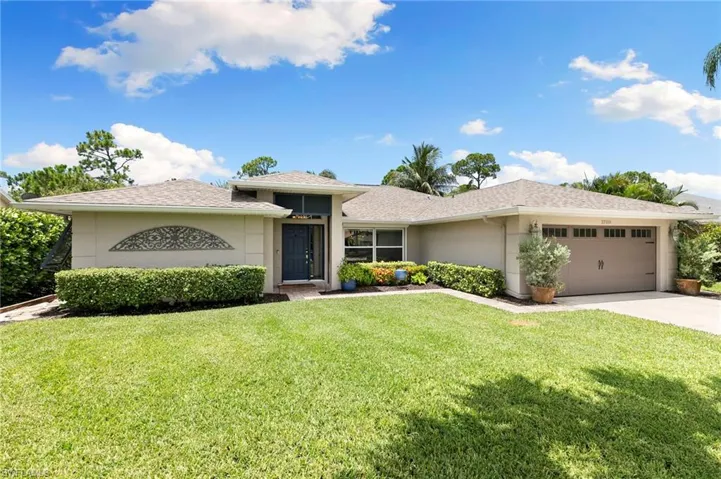 Prairie-style home featuring a garage, stucco siding, a front yard, concrete driveway, and a shingled roof