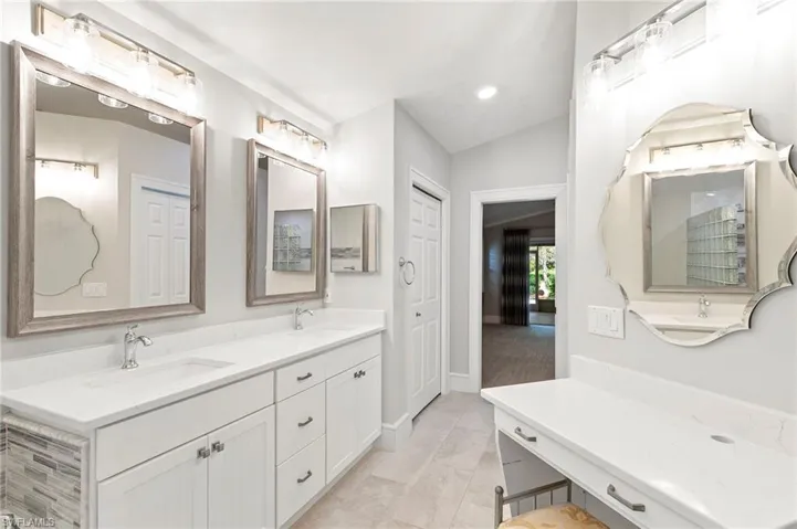 Full bath featuring double vanity and recessed lighting