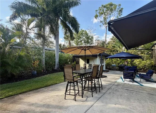 View of patio featuring outdoor dining space and a grill
