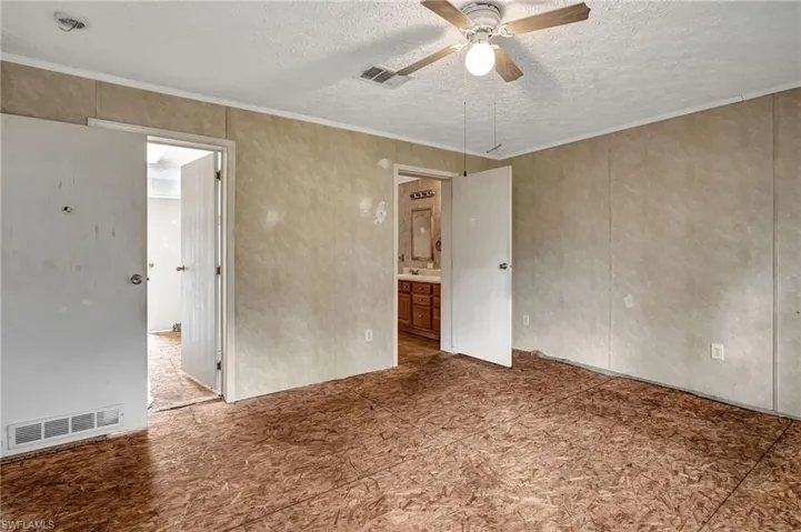 Door on the left is the walk-in closet with access from the bathroom also. Door on the right is the bathroom. Carpet has been pulled up.