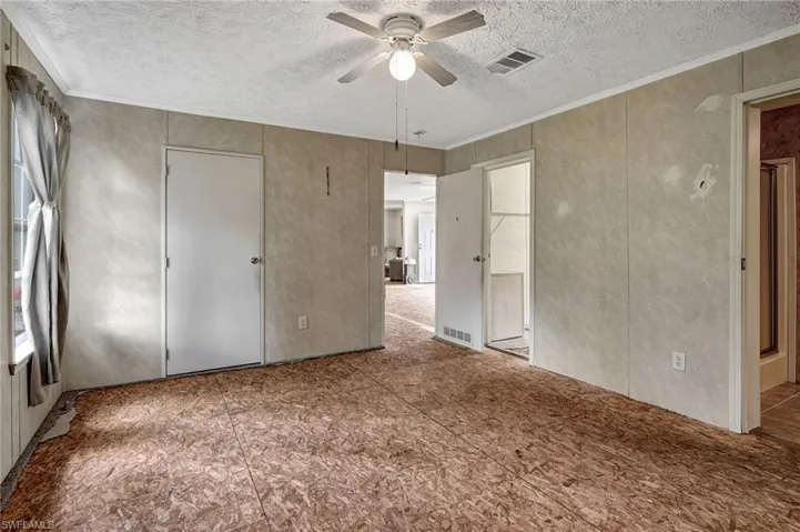 Door on the left nearest the windows is an additional closet. Door in the middle leads to the living room. Door on the right is the walk-in closet with access from the bathroom also. Partial door opening is to the batroom.