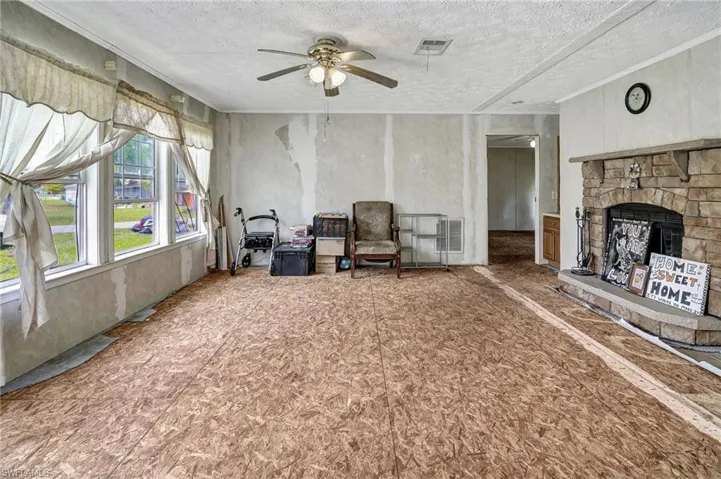 Walls have been prepped for paint and the carpet has been pulled up.