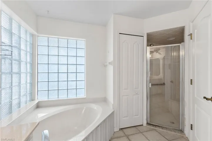 Bathroom with tile patterned flooring and separate shower and tub