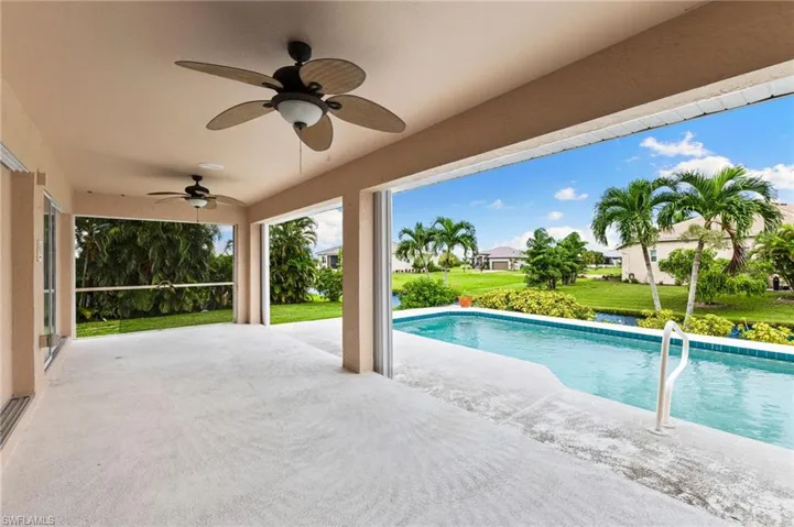 View of pool with a lawn, a patio, and ceiling fan