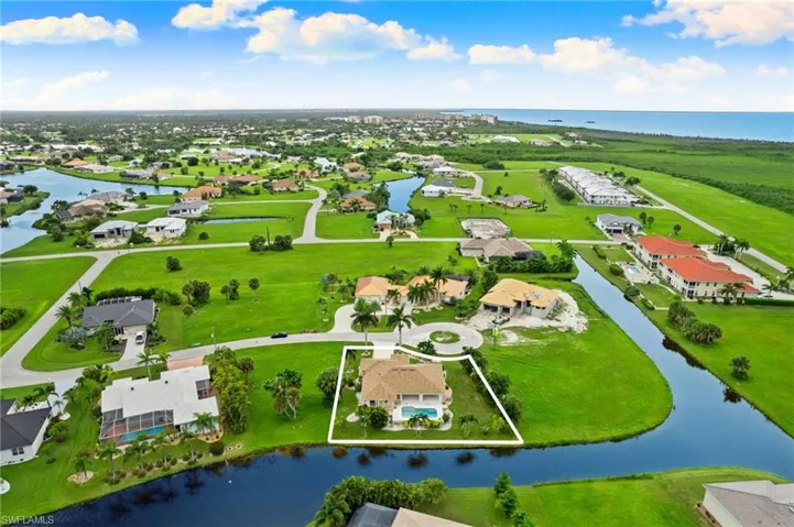 Birds eye view of property with a water view