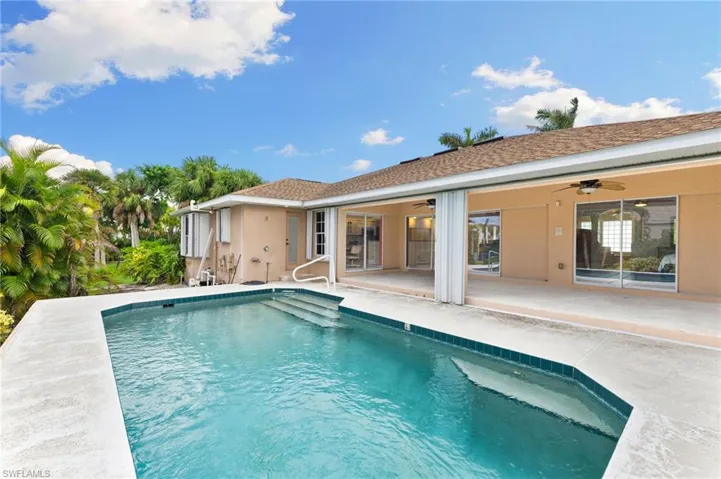 View of swimming pool with a patio area and ceiling fan