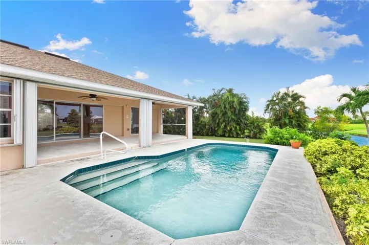 View of pool with ceiling fan and a patio area
