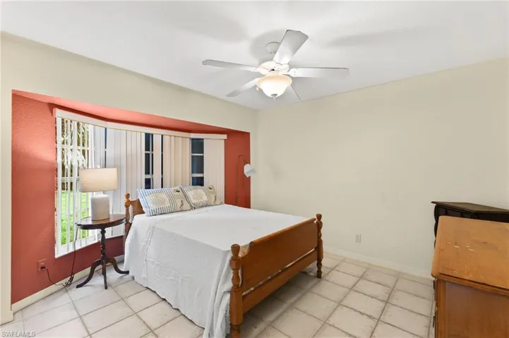 Tiled bedroom with ceiling fan