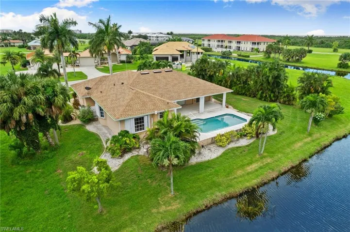 Birds eye view of property with a water view