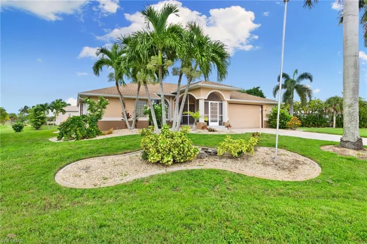 Mediterranean / spanish-style house with a front lawn and a garage