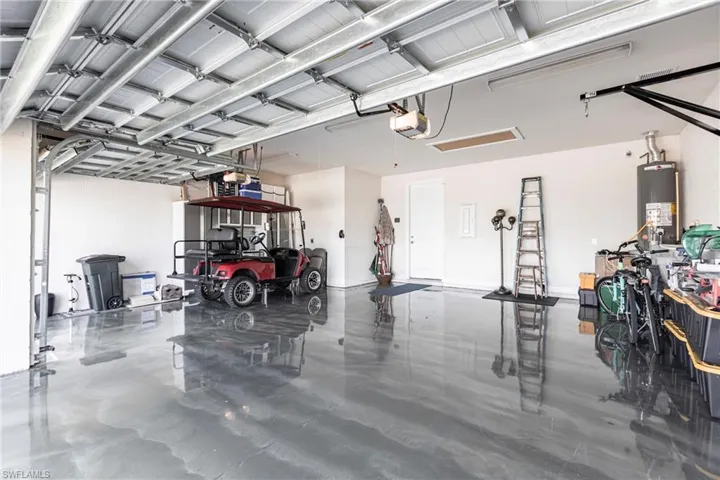 Garage with a garage door opener and gas water heater