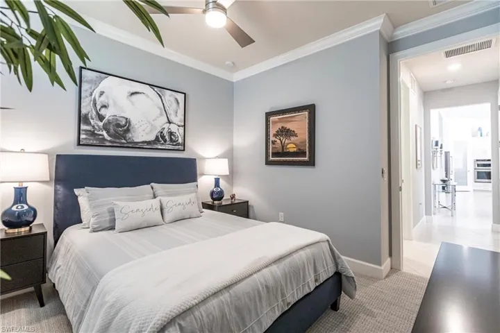 Bedroom with ceiling fan and crown molding